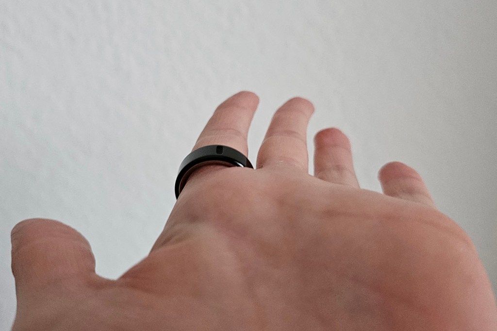 Eine Handinnenfläche mit dem Oura Ring 4 am Zeigefinger.